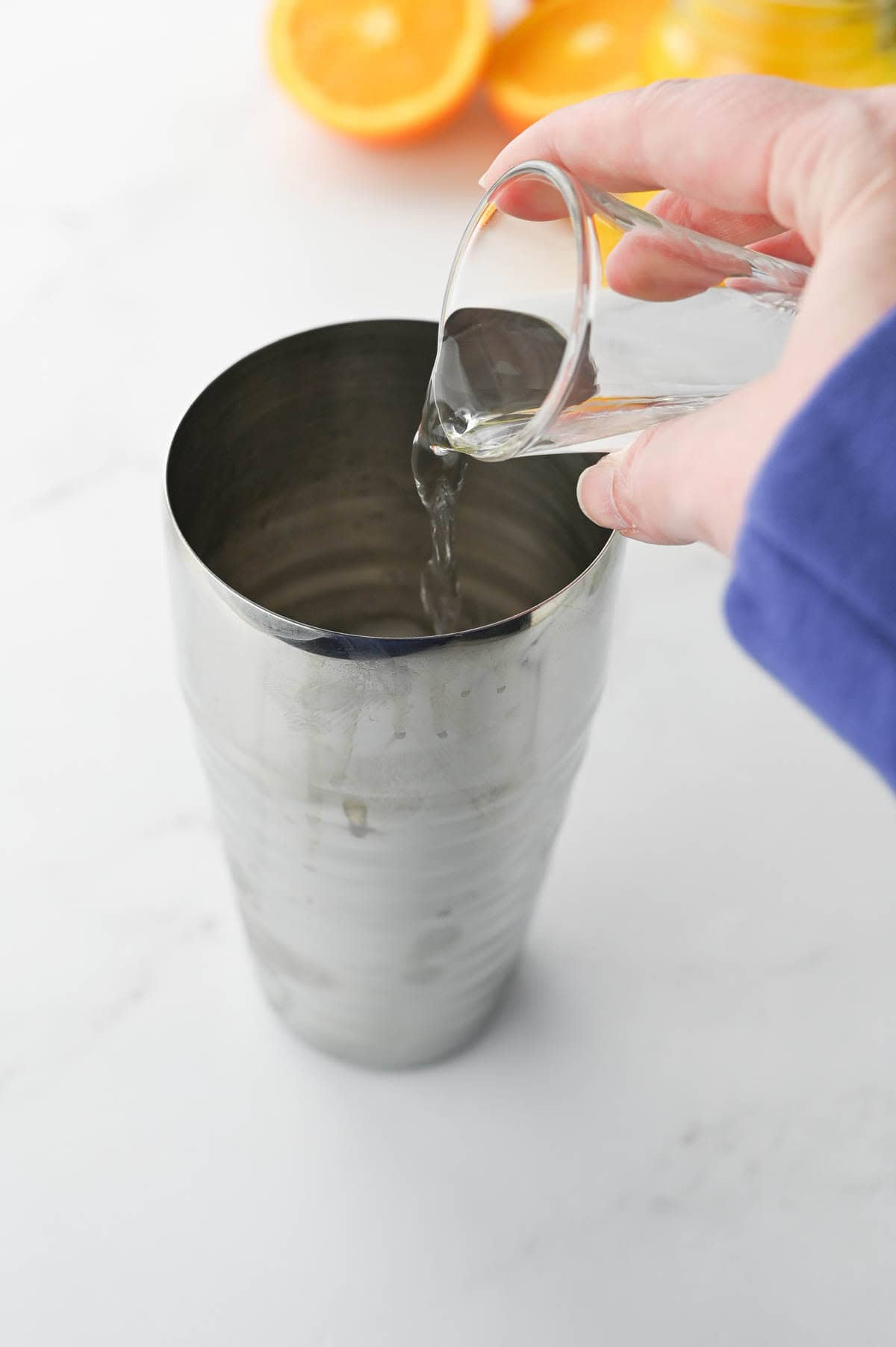 Pouring rum into a cocktail shaker.