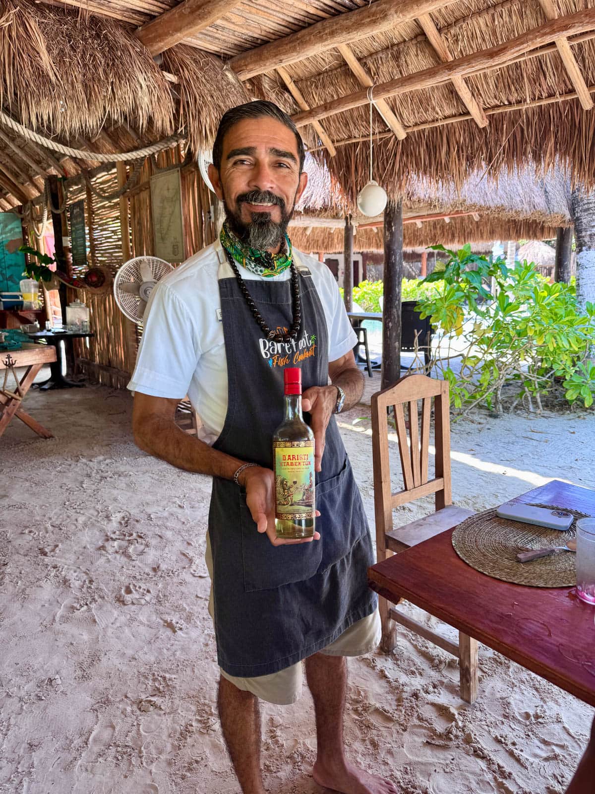 Man holding a bottle of liquer.