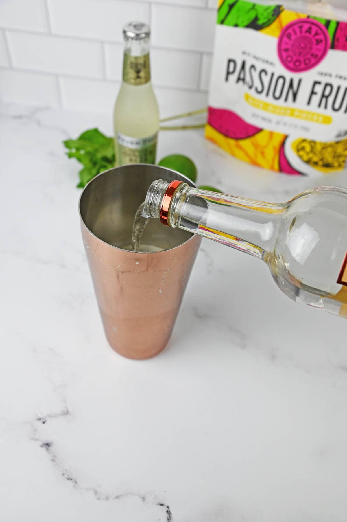 Pouring vodka into cocktail shaker.