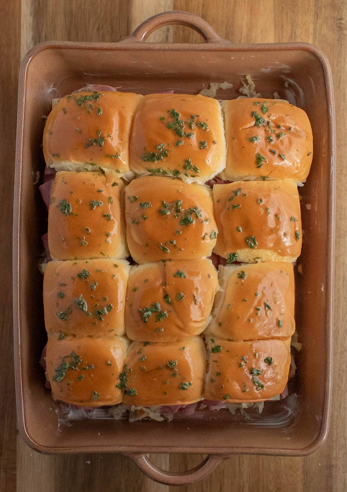 Slider sandwiches brushed with oil dressing on top.