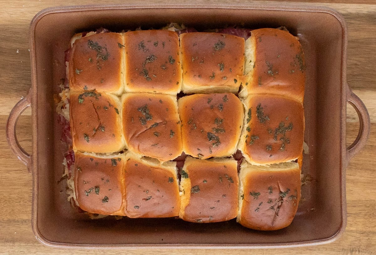 Browned sliders in a baking dish.