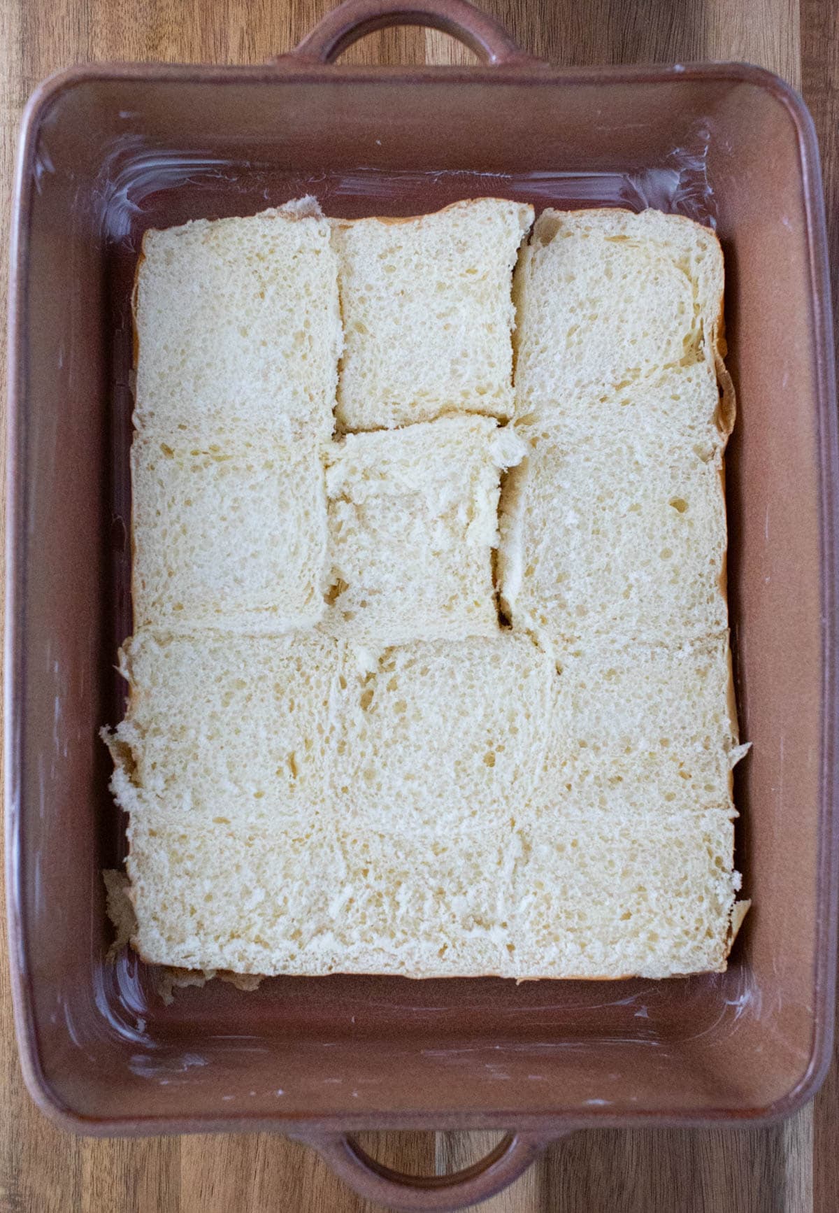 Bottoms of rolls in greased baking dish.