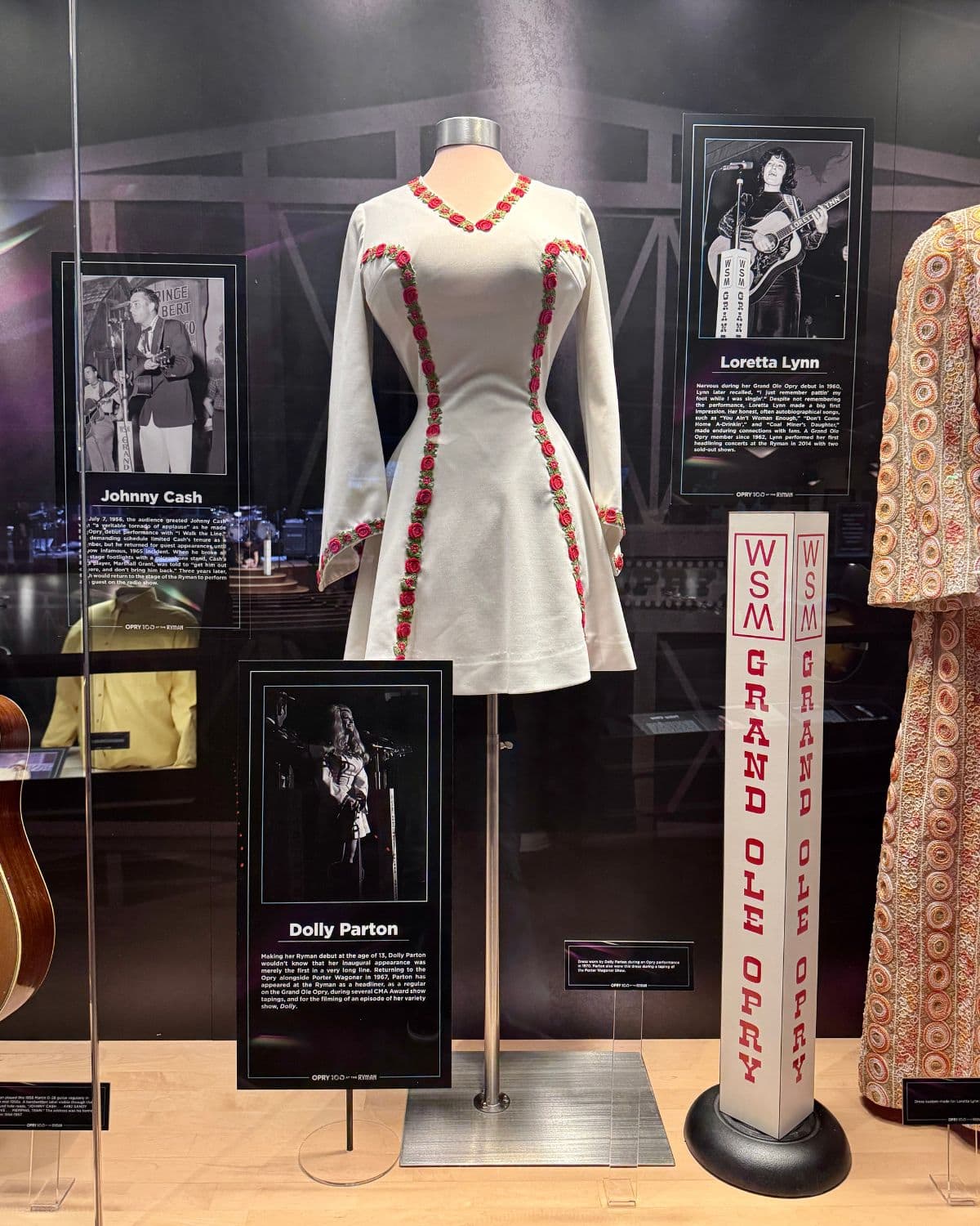 Photos and memorabilia behind glass in a museum.