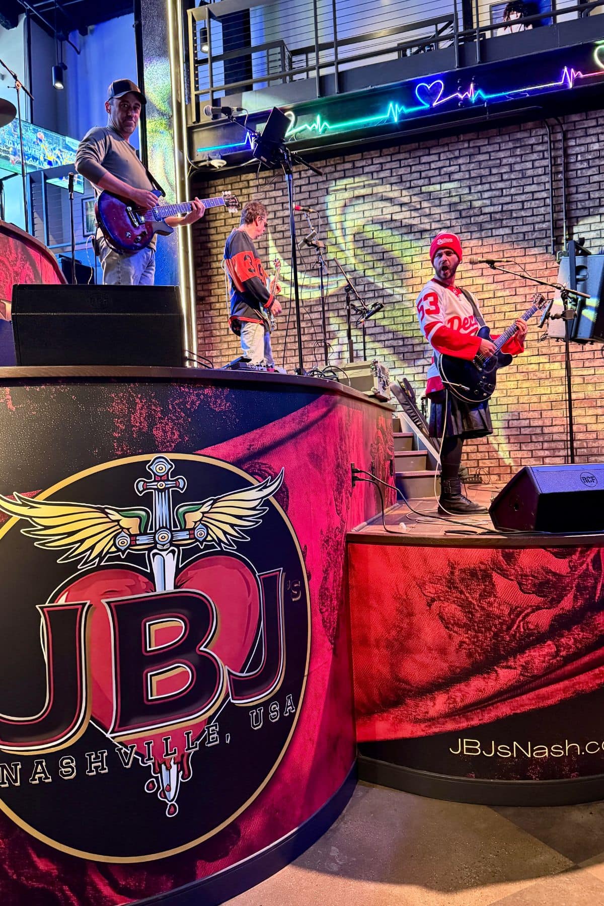 Band playing on a stage with a sign that says JBJ Nashville, USA.