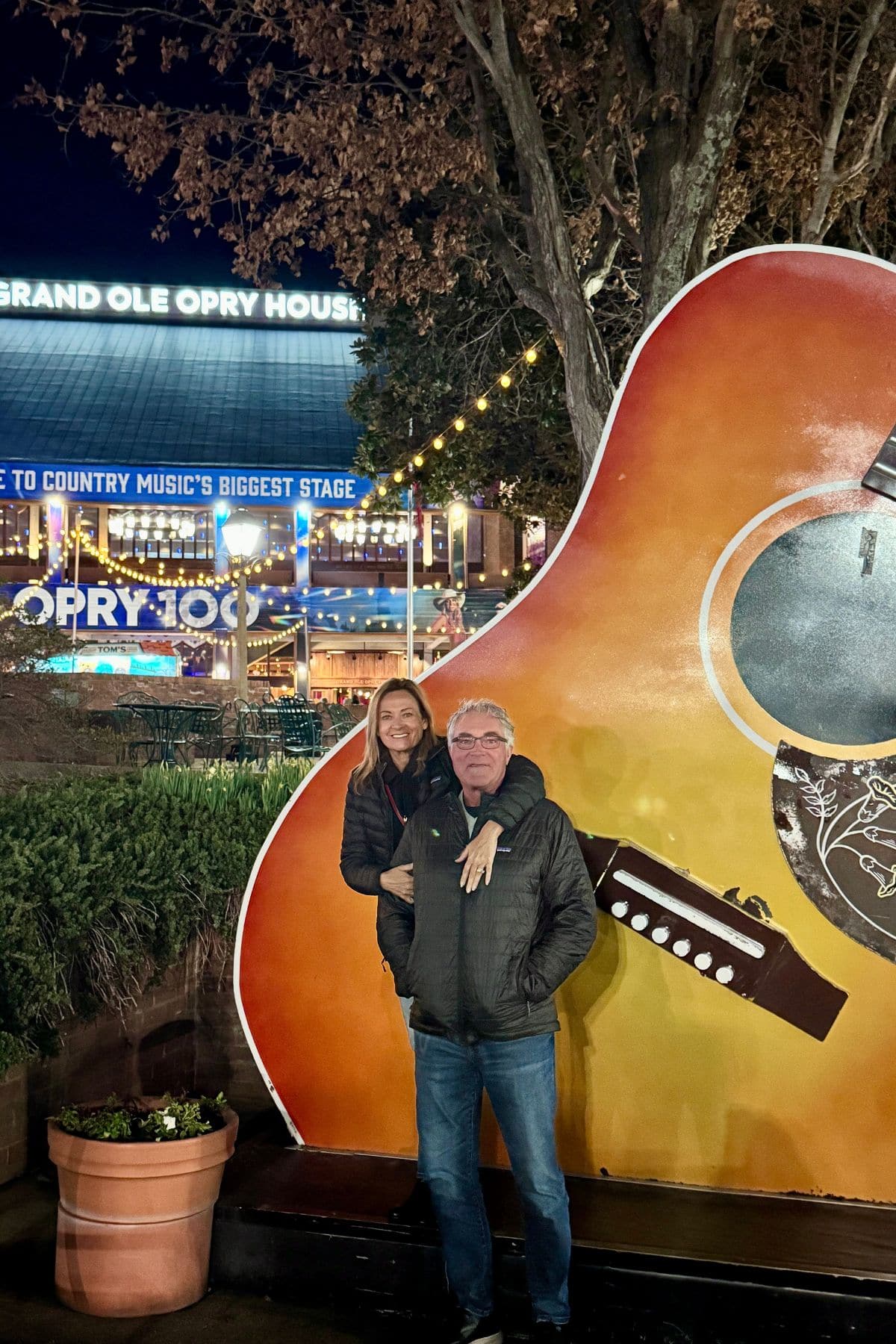 Woman and man in front of Grand Ole Opry House in Nashville.