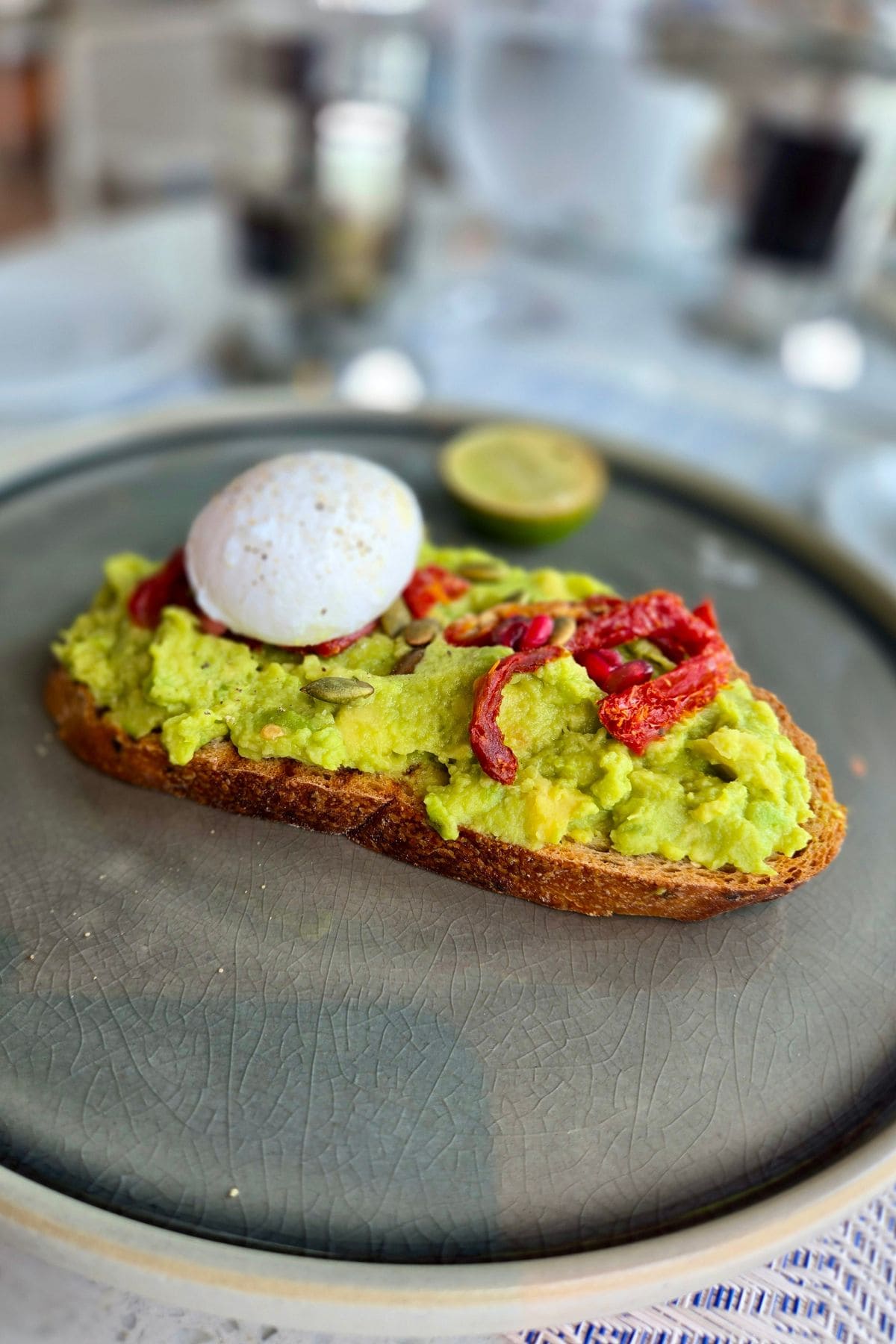 Toast with avocado, sundries tomatoes, and a soft boiled egg.
