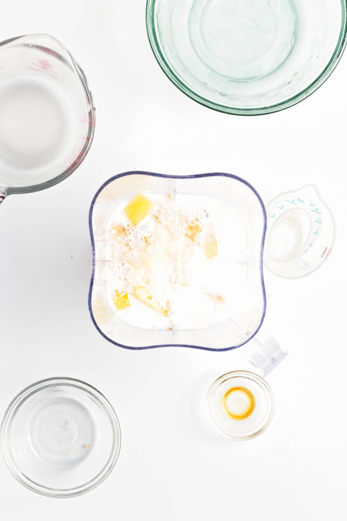 Pineapple and coconut milk in blender.