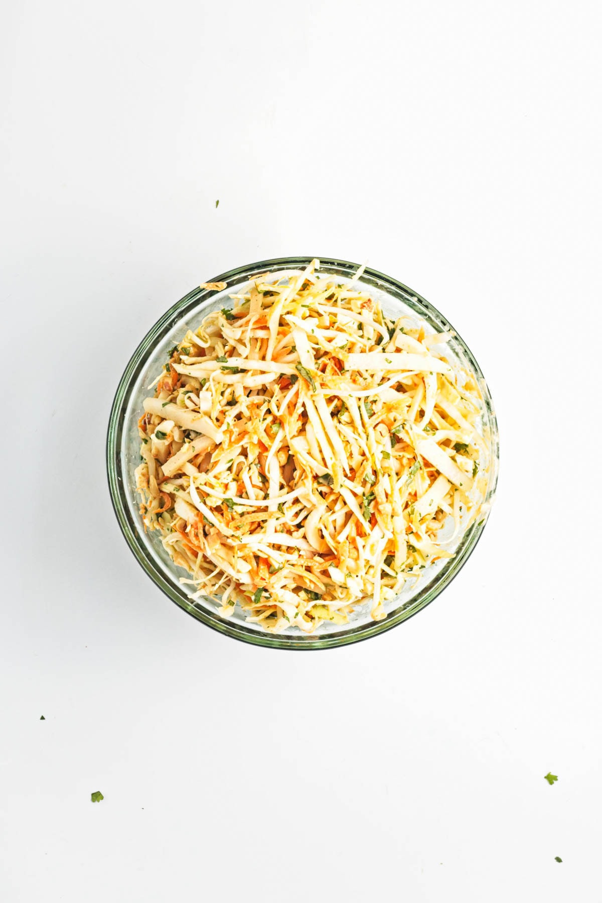 Glass bowl of shredded cabbage and carrots.