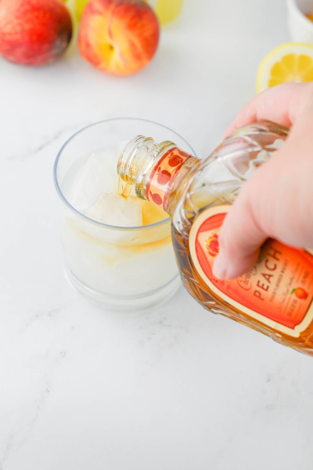 Pouring Crown Royal into a glass.
