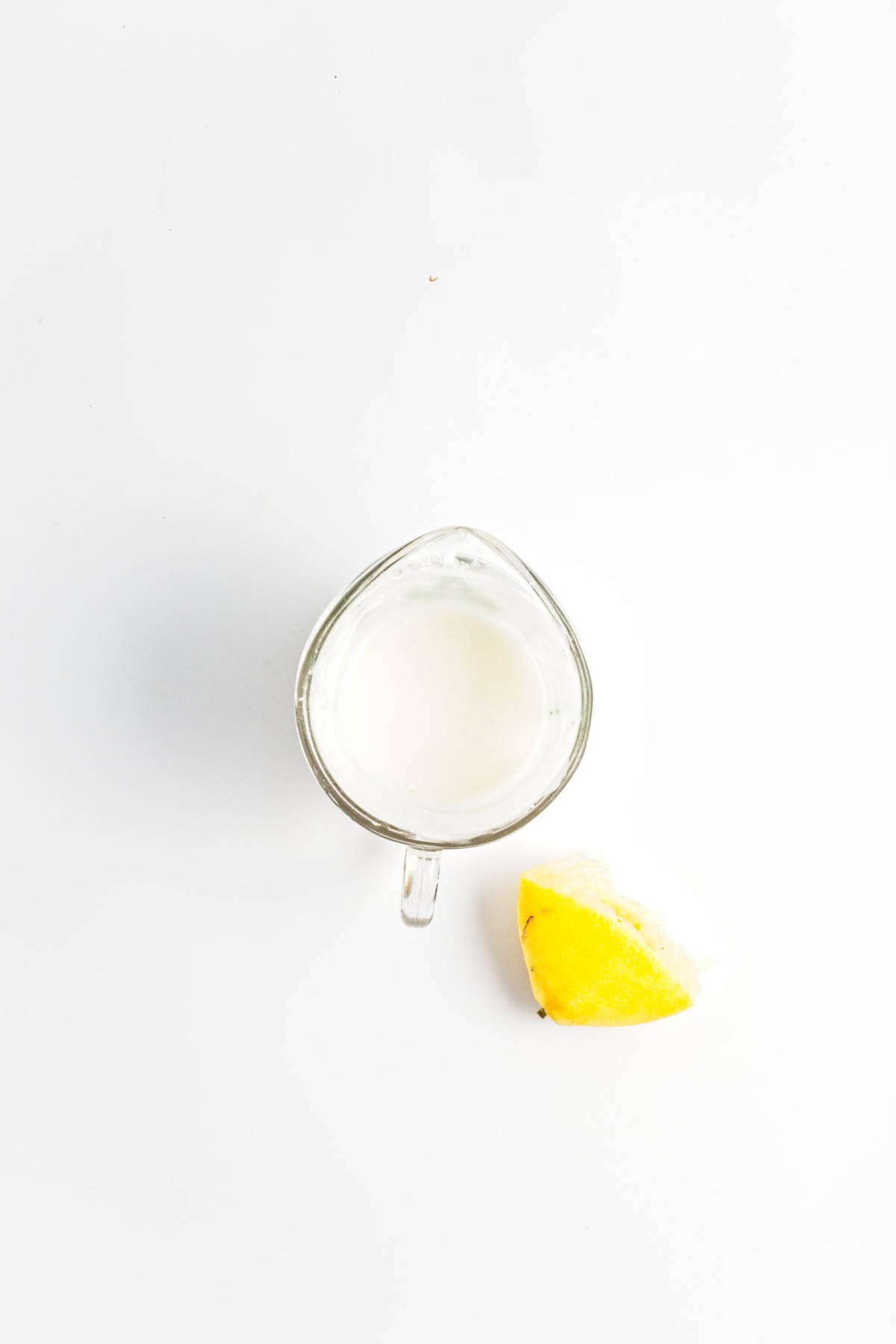 Lemon and milk in a measuring cup.