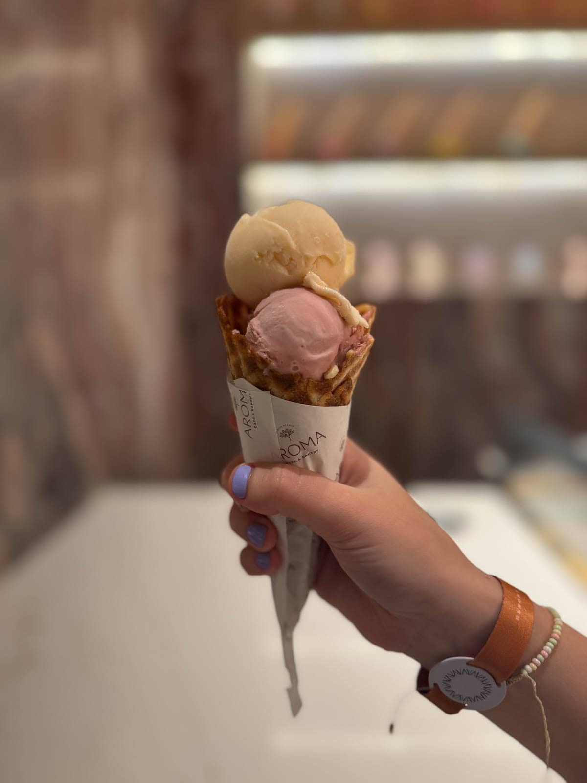 Hand holding ice cream cone.