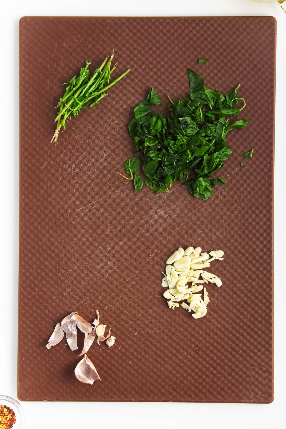Cutting board with basil and garlic.