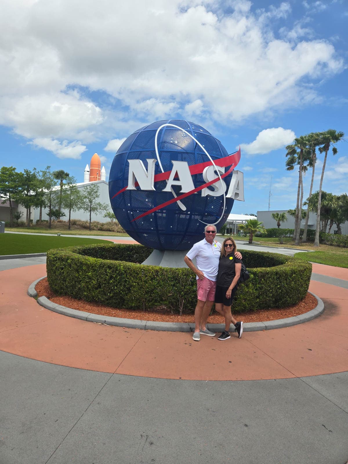 Man and woman in front of Nasa sign.