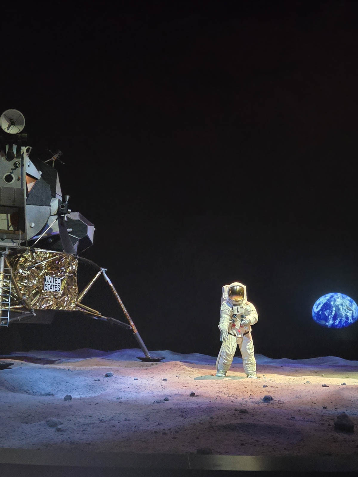 Astronaut and space craft in space with earth to the side.