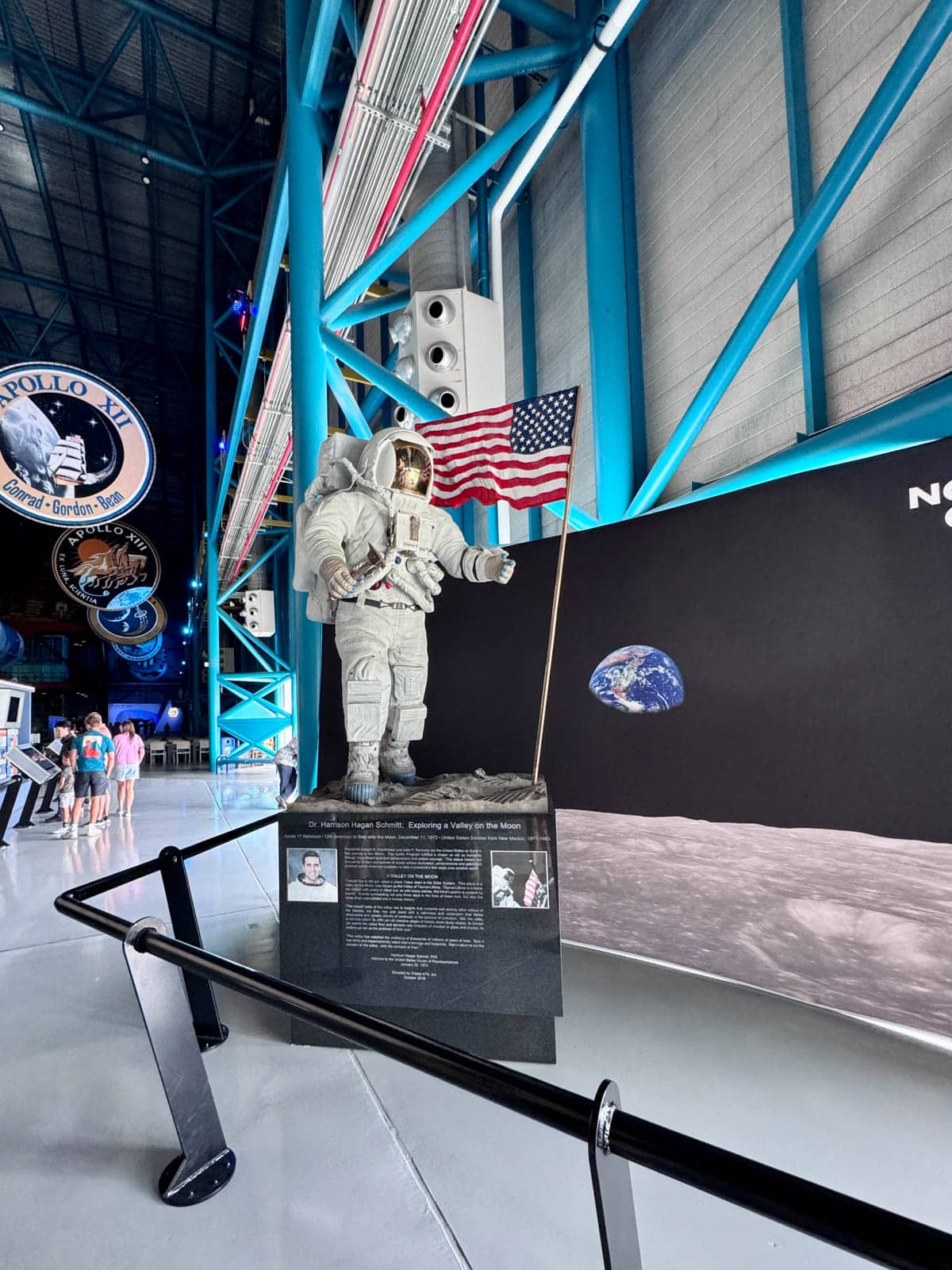 Replica of an astronaut next to an American flag.