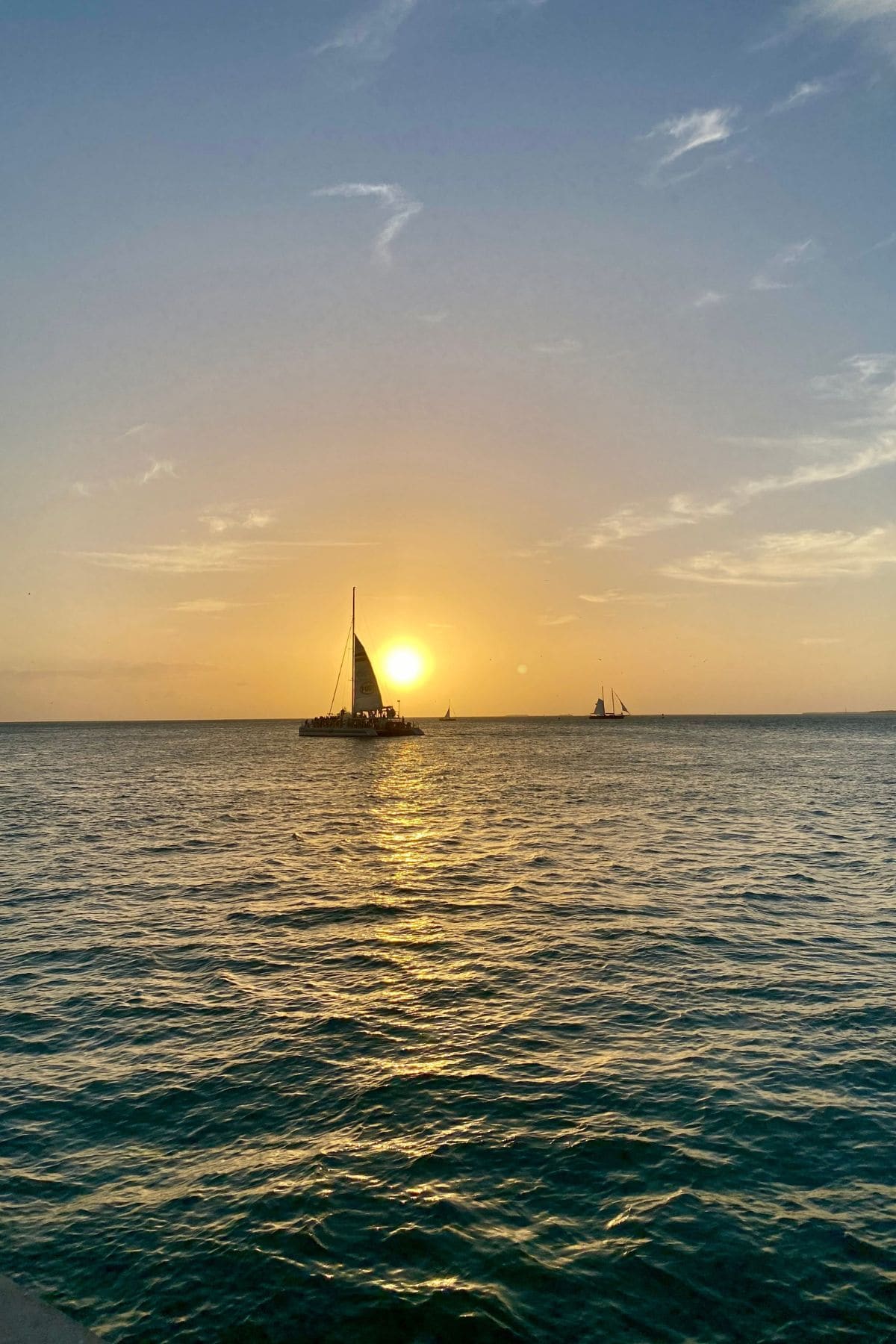 Sunset with sailboat in front.