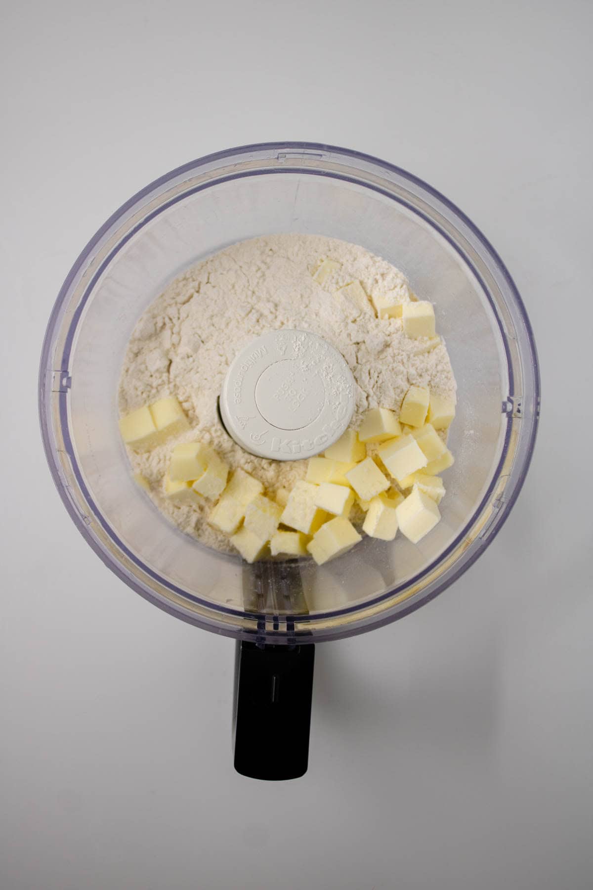 Butter, flour, and salt in food processor.