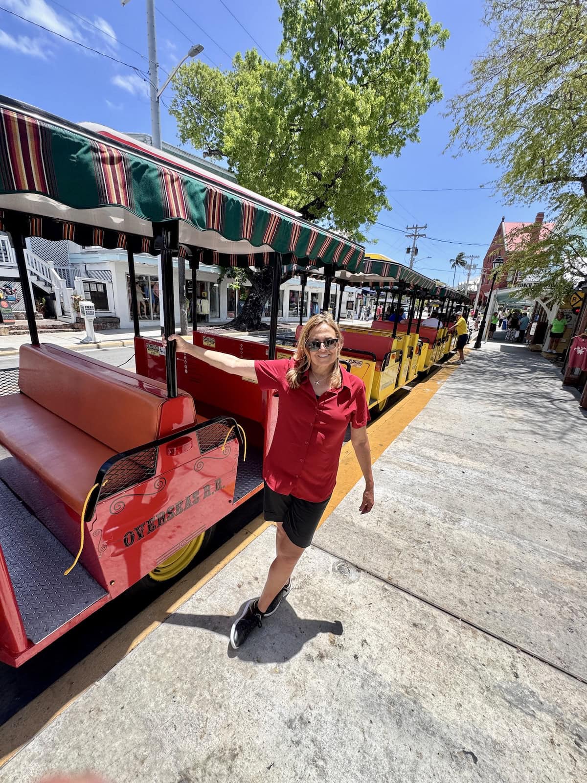 Woman holding on to trolley in Key West, Florida.