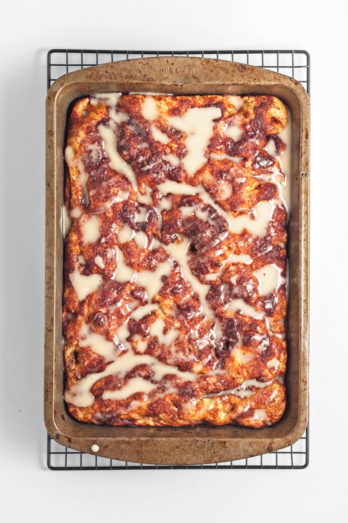 Baked cinnamon and sugar focaccia bread with icing.