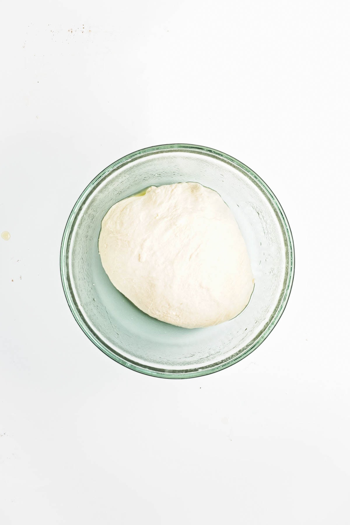 Dough in glass bowl.