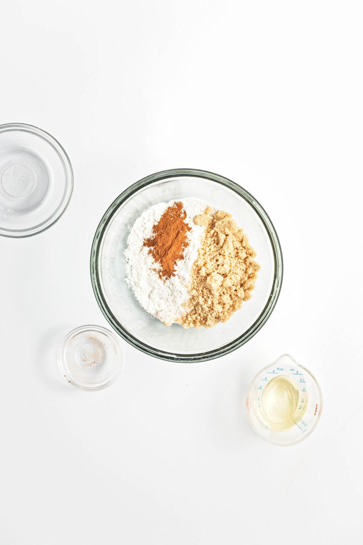 Flour, brown sugar, and cinnamon in a glass bowl.