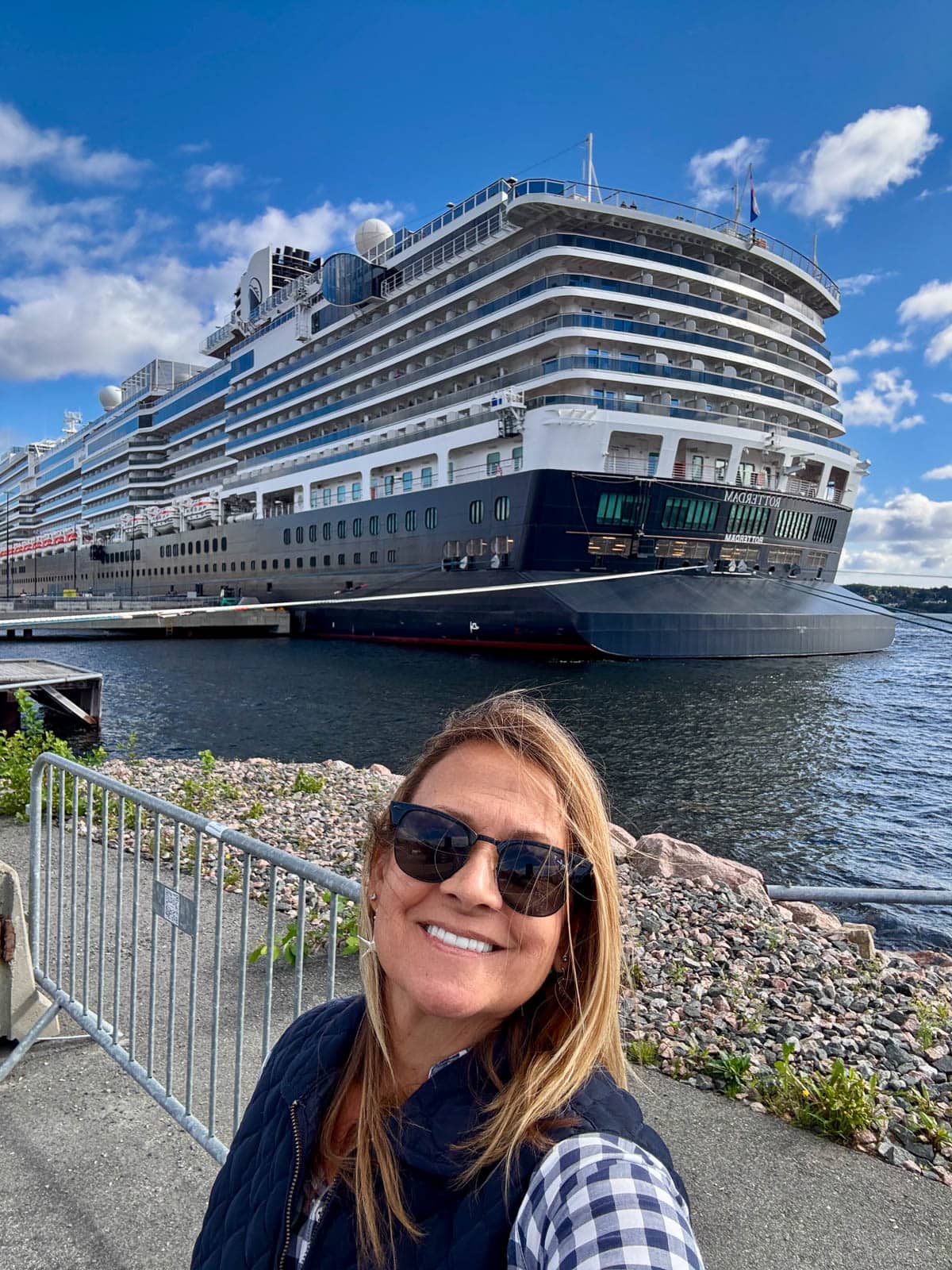 Woman in front of cruise ship.