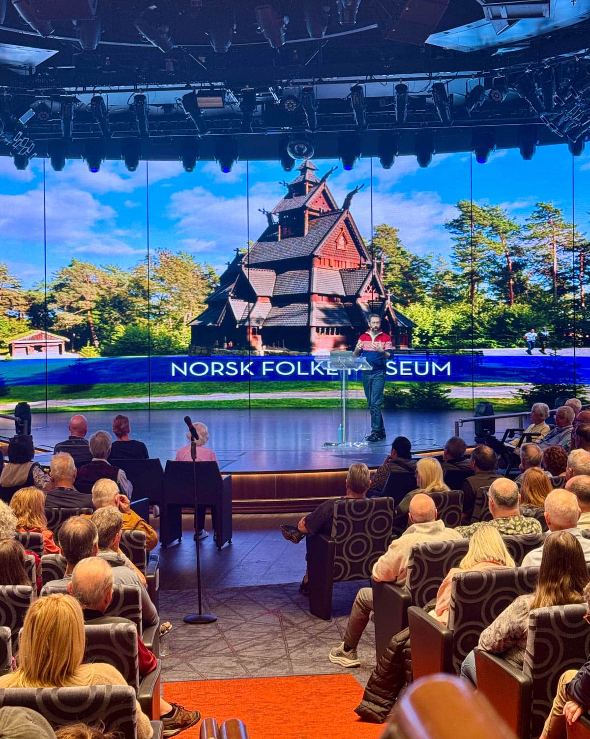 Man giving a presentation to a seated audience.