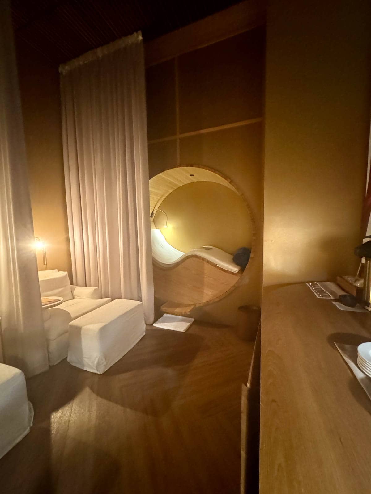 Spa room in a hotel with chairs and curtains.