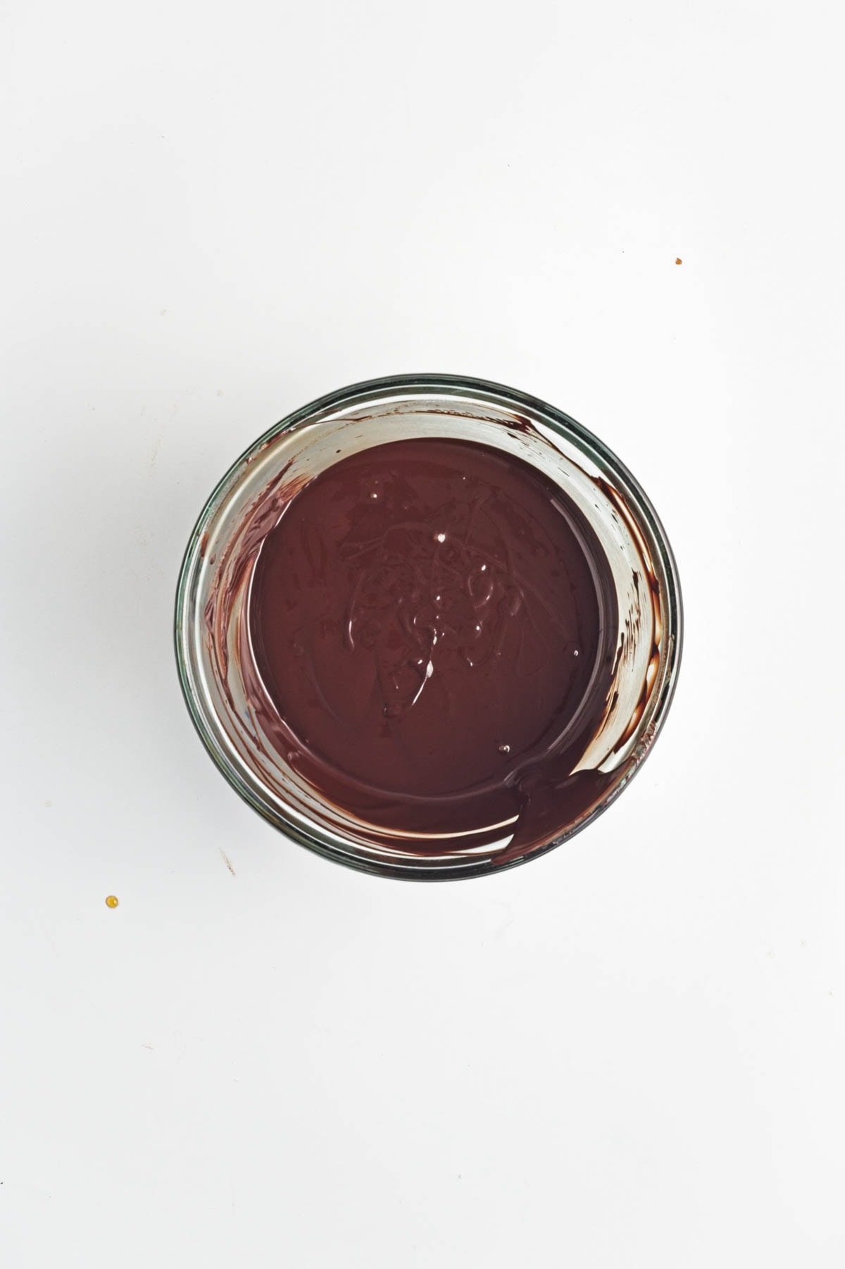 Melted chocolate in a glass bowl.