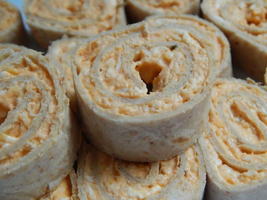 Close up of cheese pinwheel sandwiches.