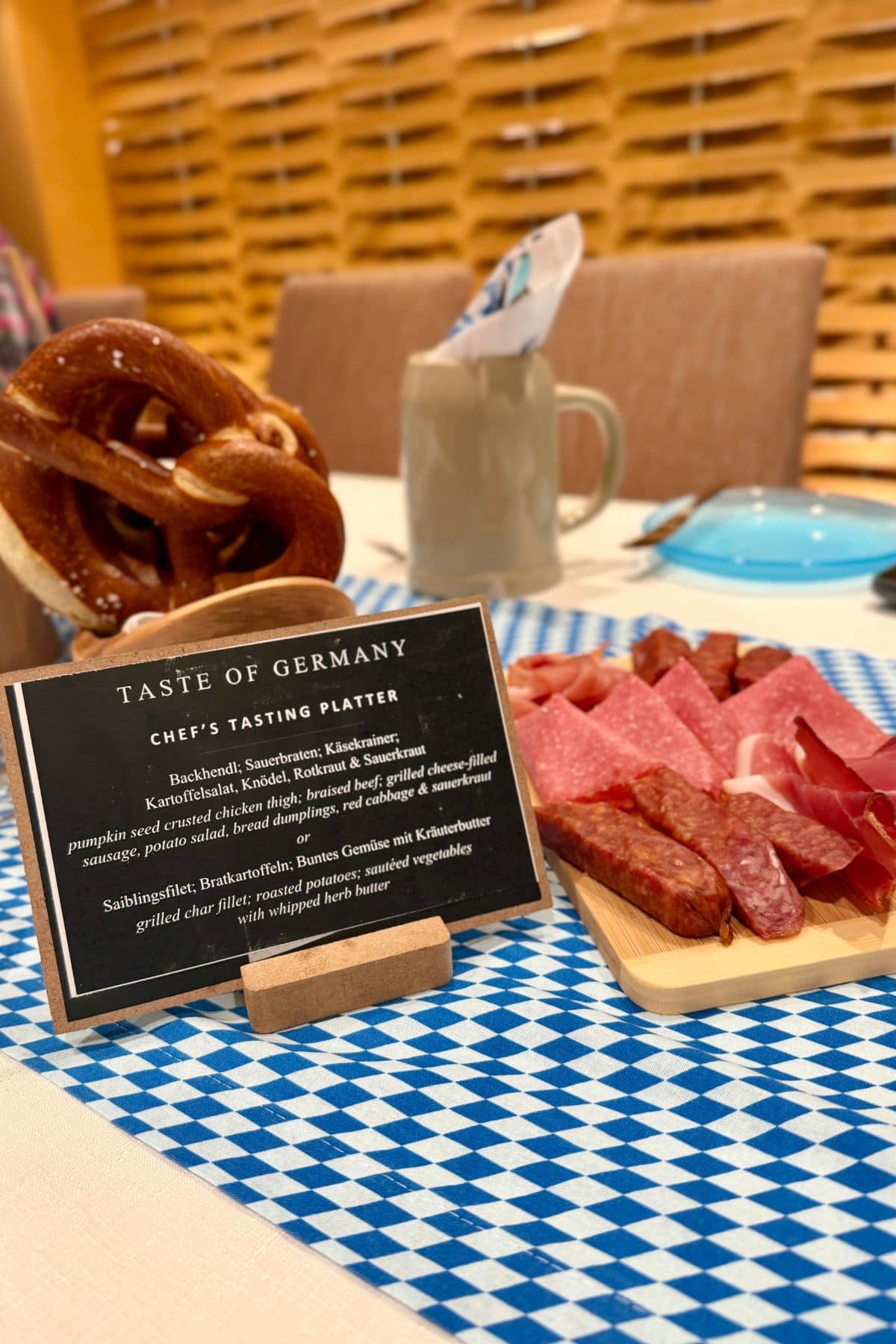 German food on a blue and white tablecloth with a sign for Taste of Germany.