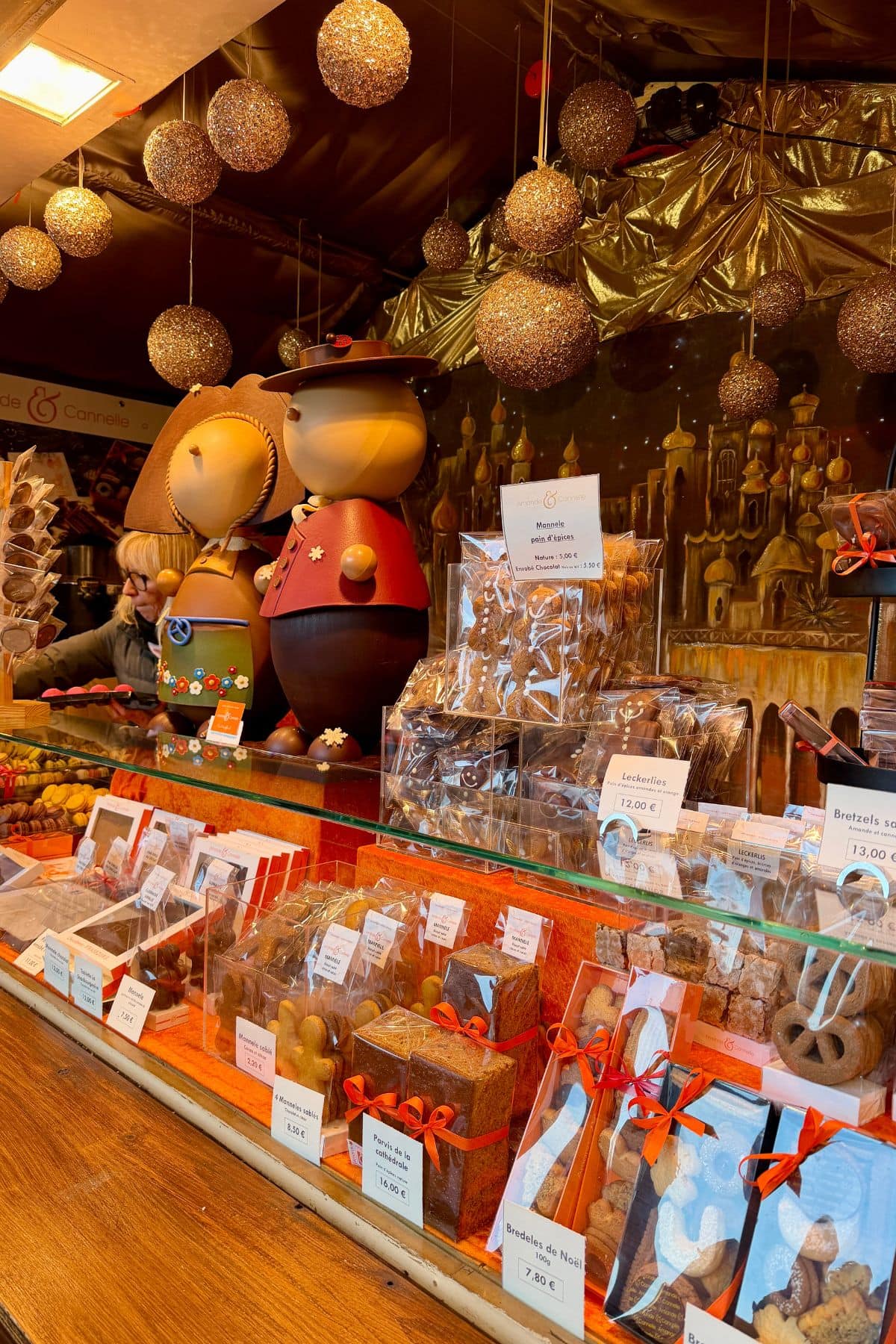 Market stall with Christmas decor and desserts.