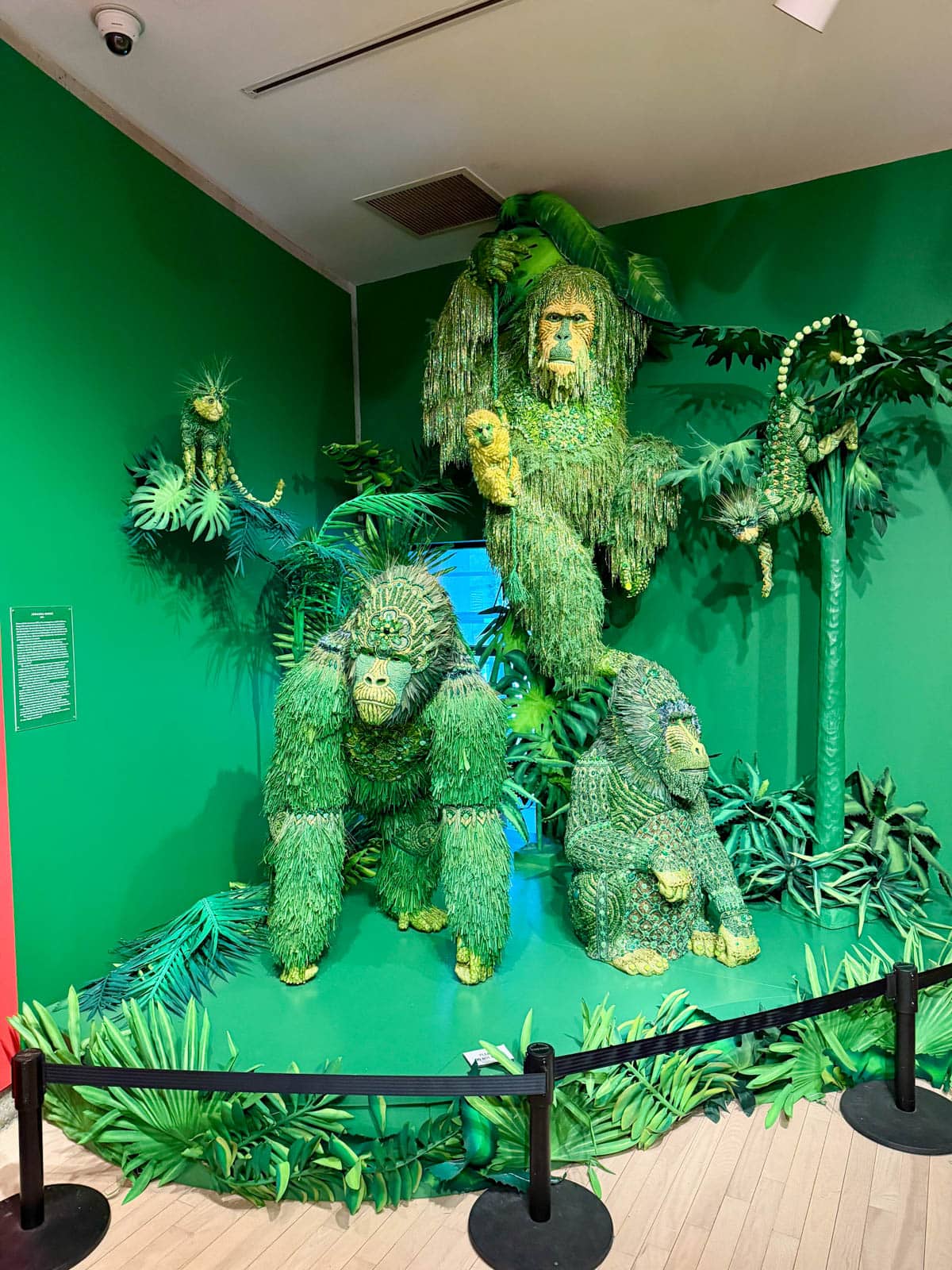 Green art installation of apes.