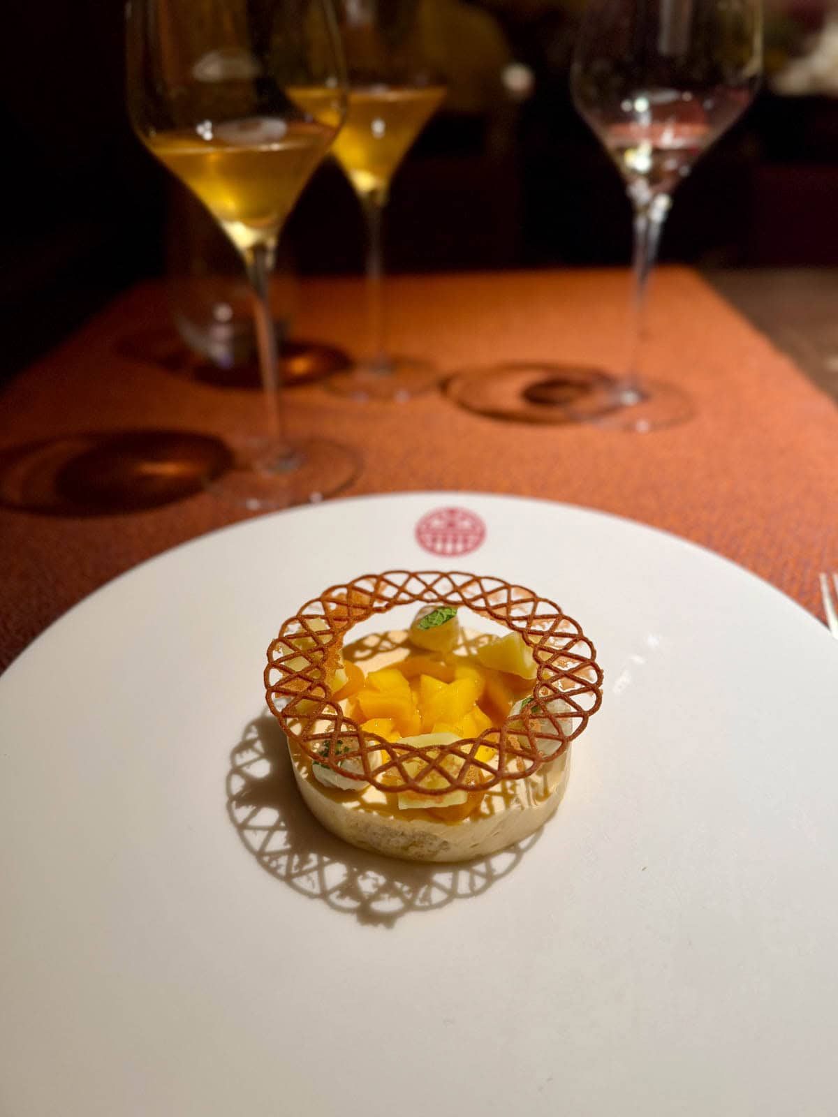 Dessert with custard topped with chopped mango.