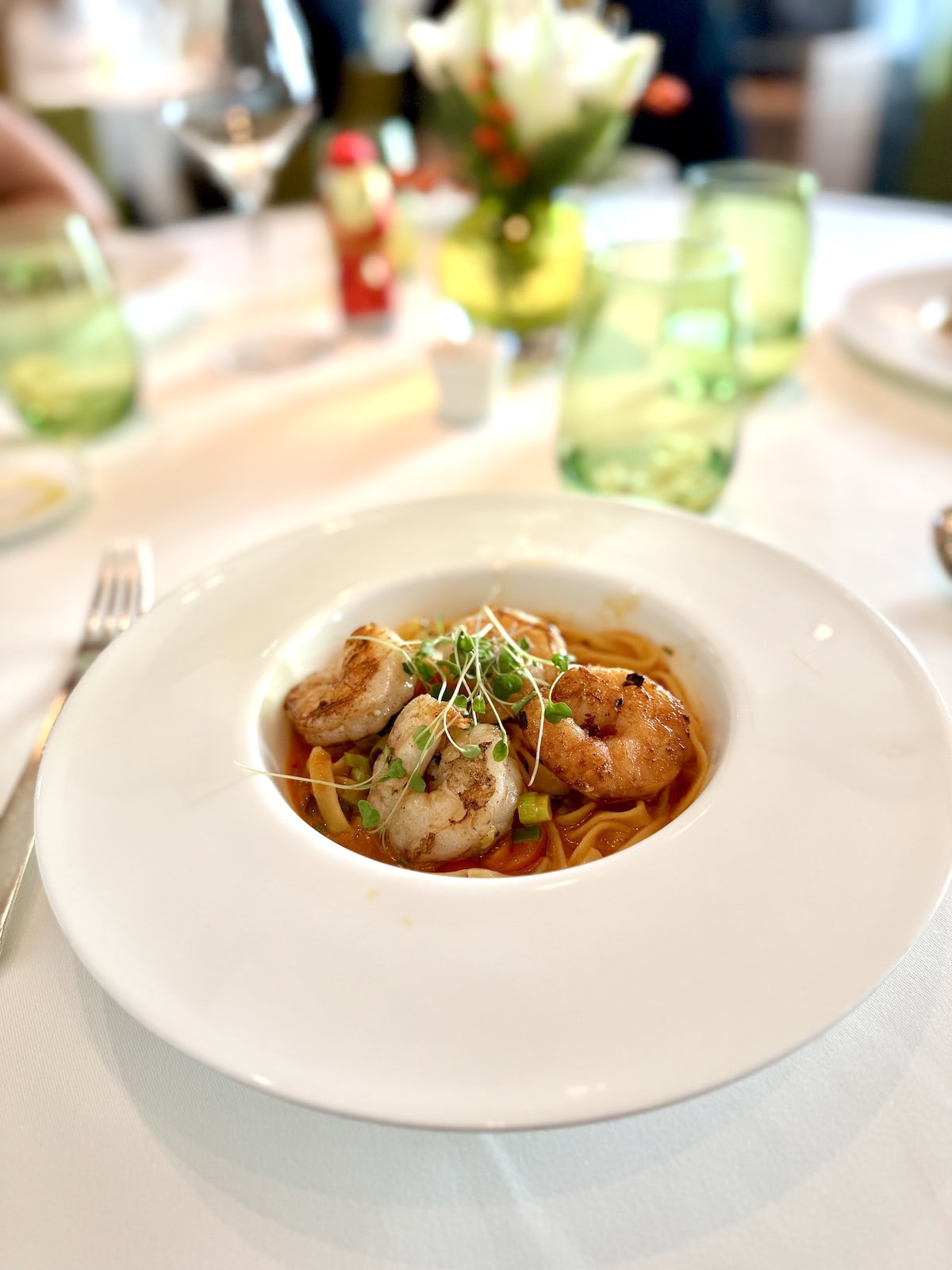 White bowl with pasta and shrimp.