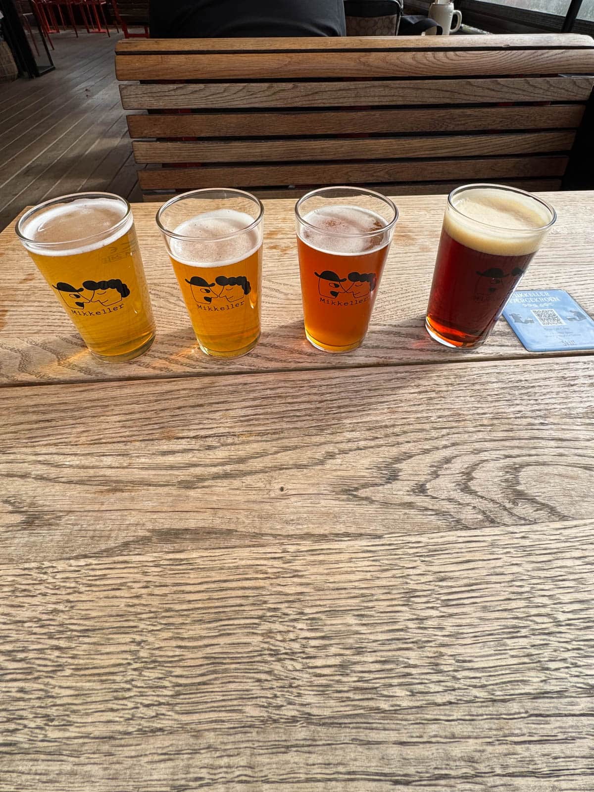 Glasses of beer on a wooden table.