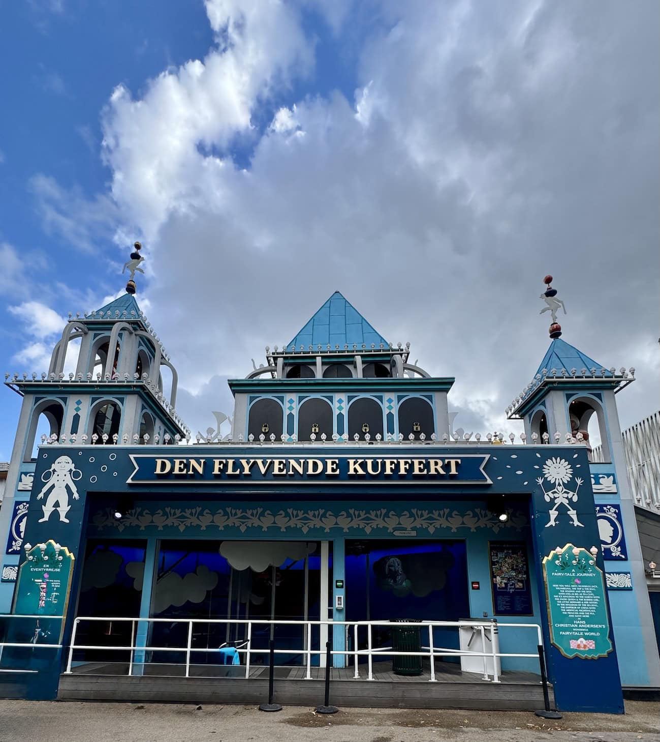 Blue and white building housing a ride at an amusement park in Denmark.