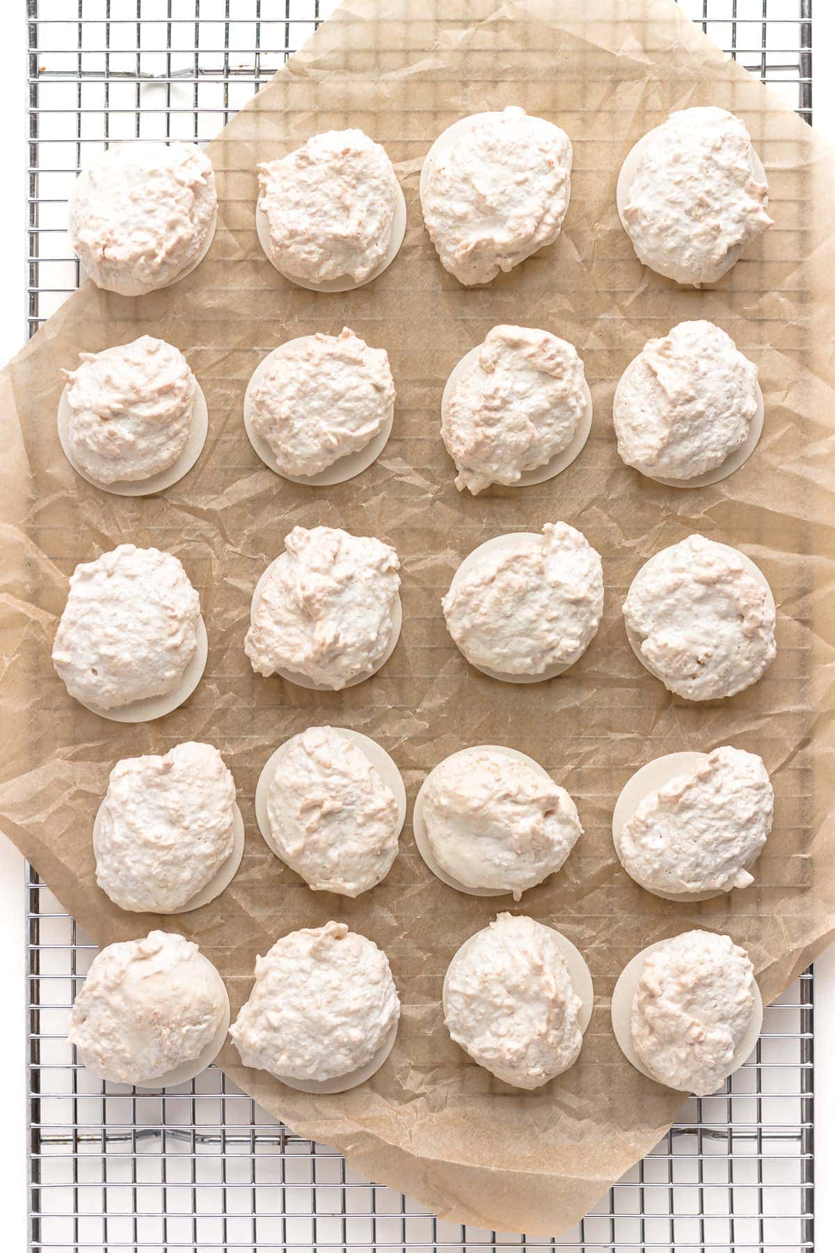 Small iced cookies on a baking sheet with parchment paper.