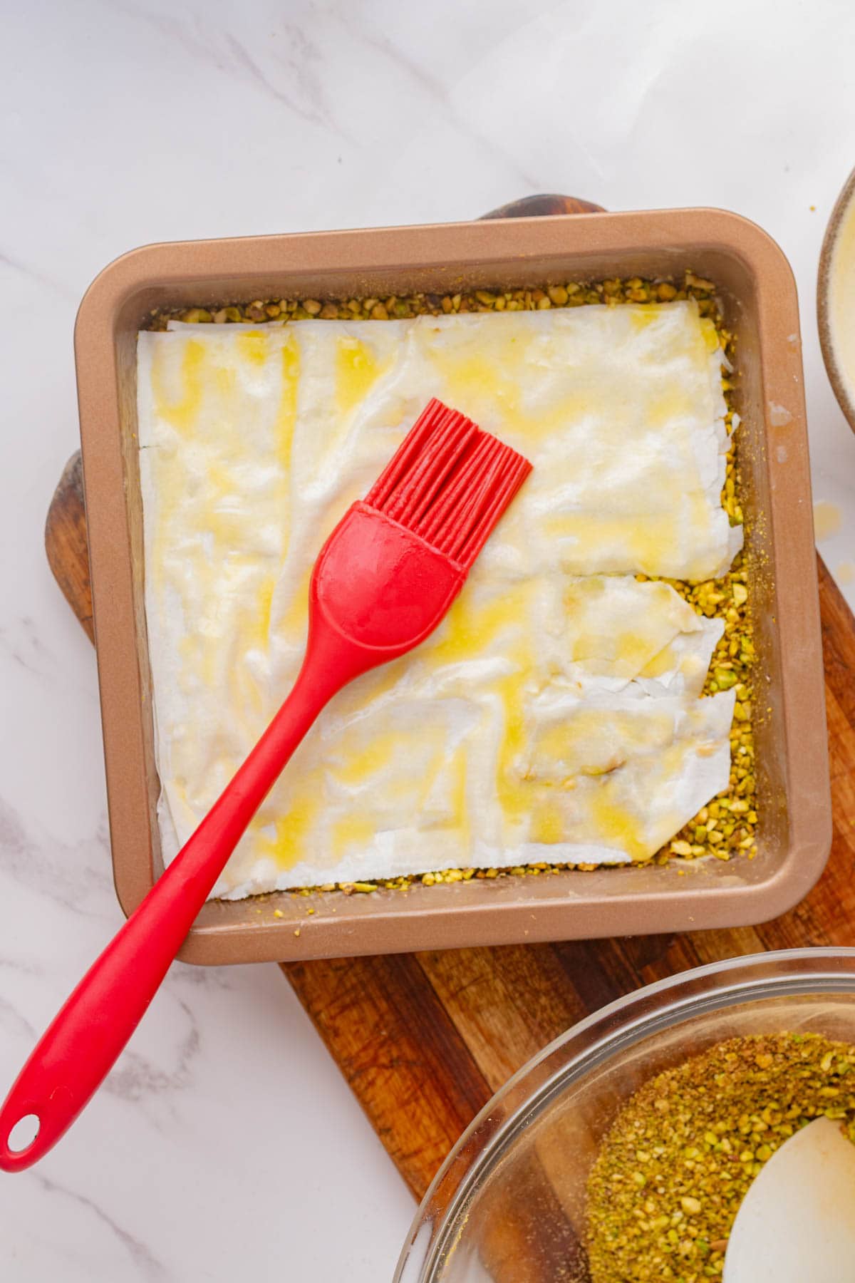 Chopped pistachio nuts covered with phyllo dough and spread with melted butter.