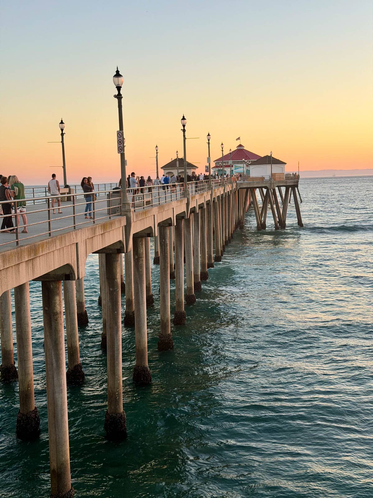 Pier at beach at sunset.