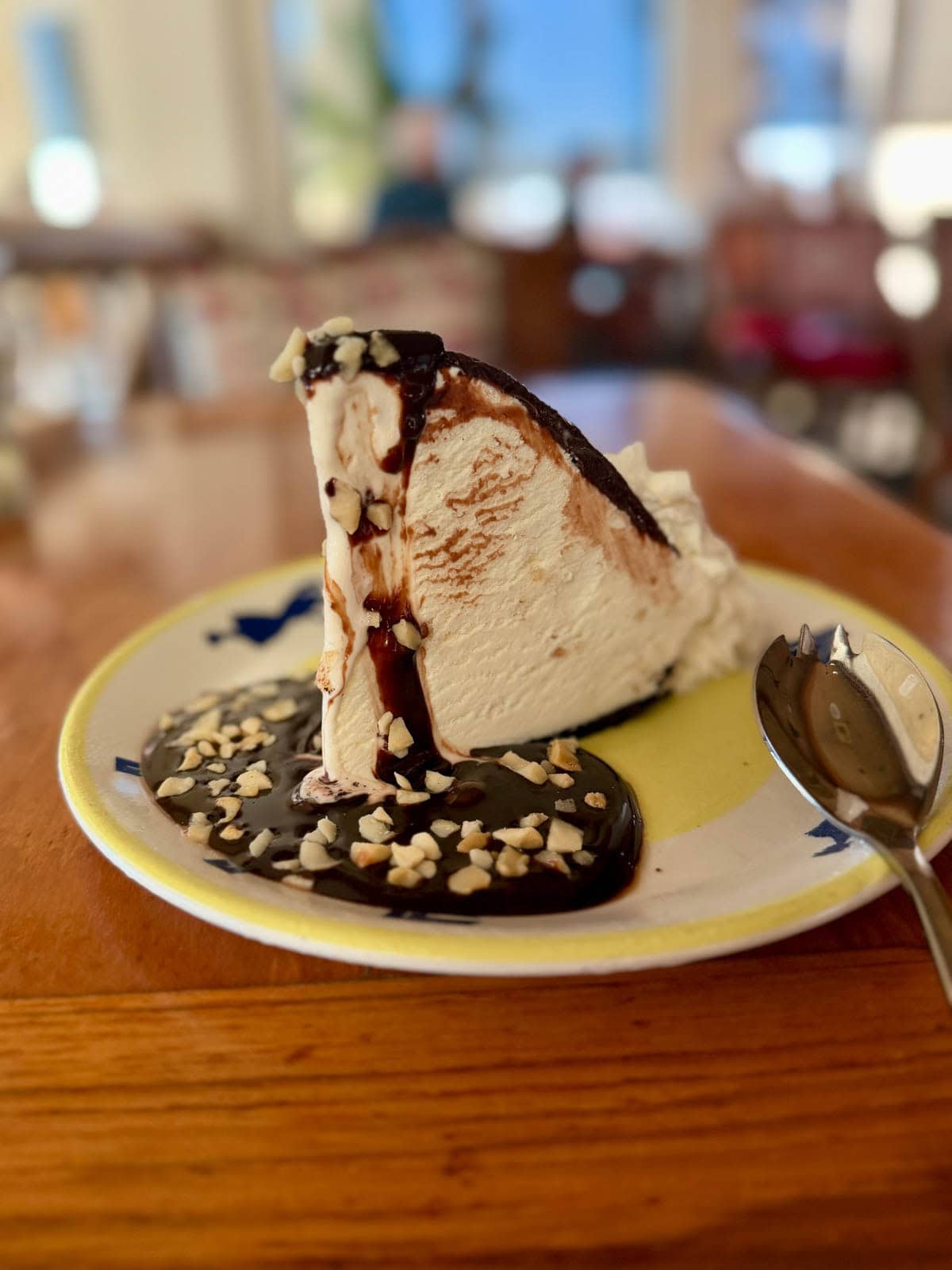 Slice of ice cream pie topped with melted chocolate.