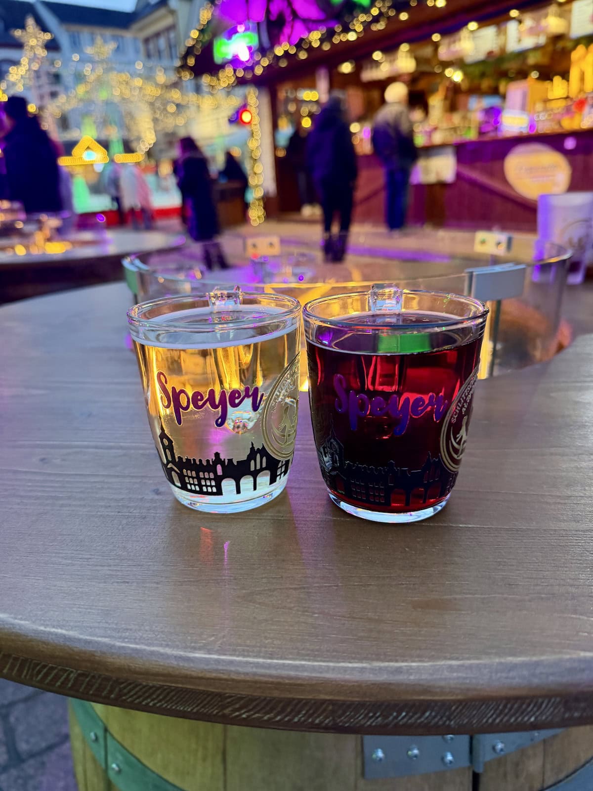 Two glass mugs filled with gluhwein at a Christmas market in Germany.