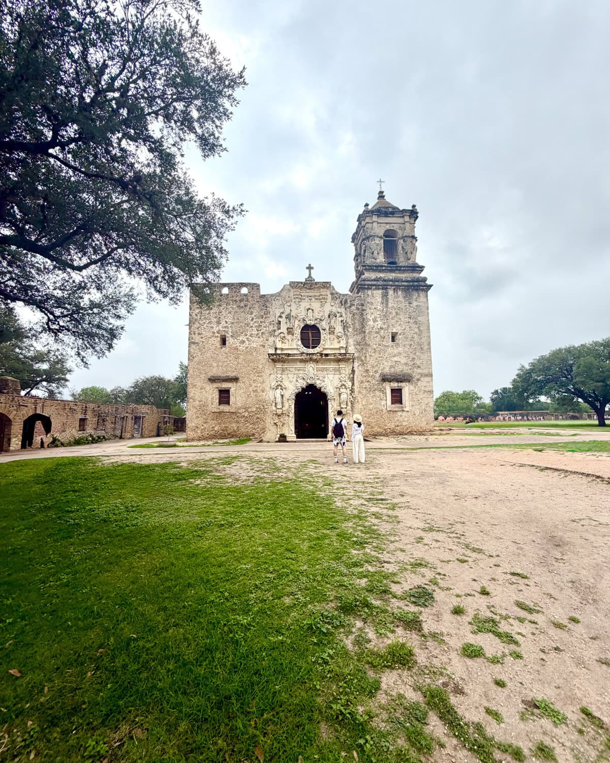 Couple standing in front of old church.