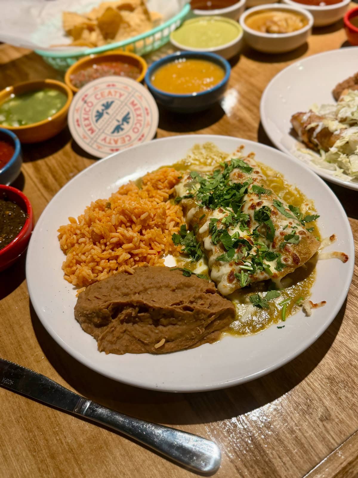 Mexican food and sauces on a wood table.